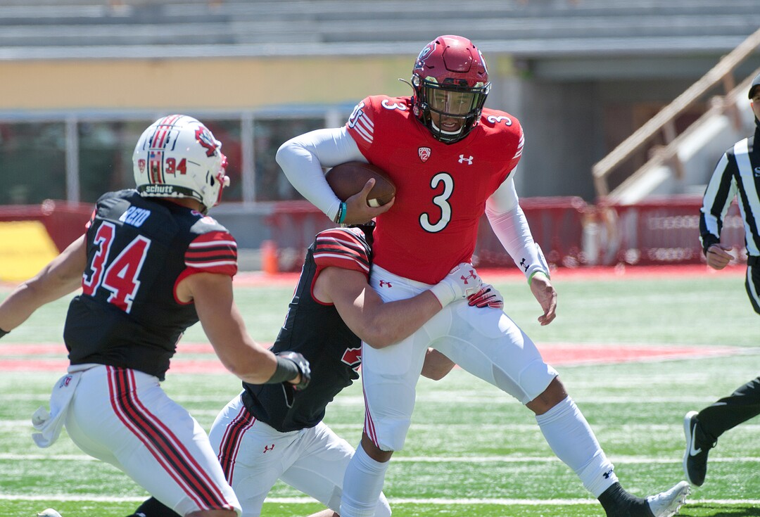 (Ed Kosmicki | Special to The Tribune) The red team corner back Drew Rawls is pursued by the black team defense during the annual spring football game at the University of Utah, 17 April 2021.