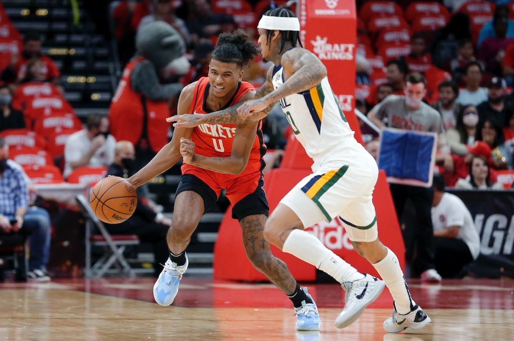 Houston Rockets guard Jalen Green (0) drives under pressure from Utah Jazz guard Jordan Clarkson, right, during the first half of an NBA basketball game Thursday, Oct. 28, 2021, in Houston. (AP Photo/Michael Wyke)