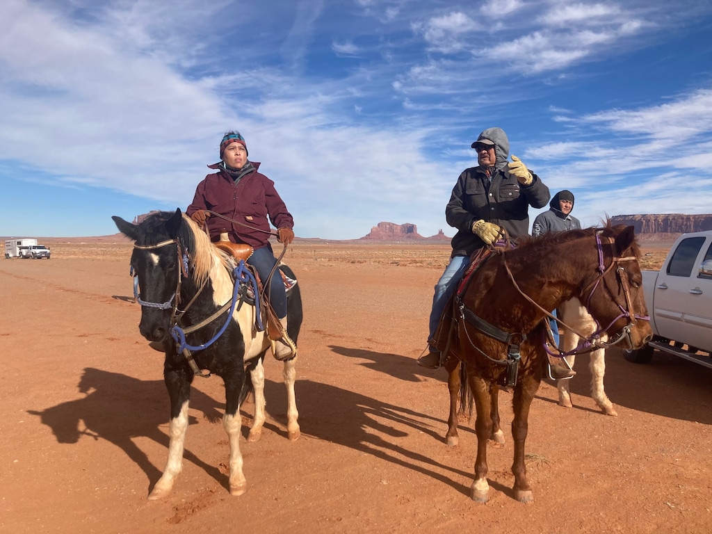 (Zak Podmore | The Salt Lake Tribune) Davina Smith (left) and her father Roy Smith ride their horses to the Monument Valley Welcome Center on Thursday, Dec. 16, 2021.