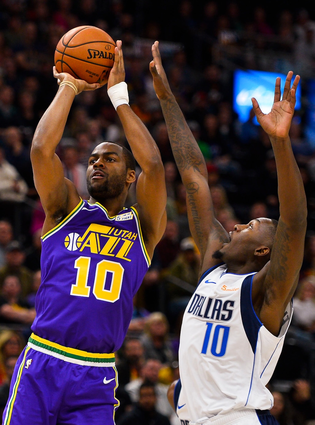 Utah Jazz guard Alec Burks (10) shoots next to Dallas Mavericks forward Dorian Finney-Smith (10) during the first half of an NBA basketball game Wednesday, Nov. 7, 2018, in Salt Lake City. (AP Photo/Alex Goodlett)