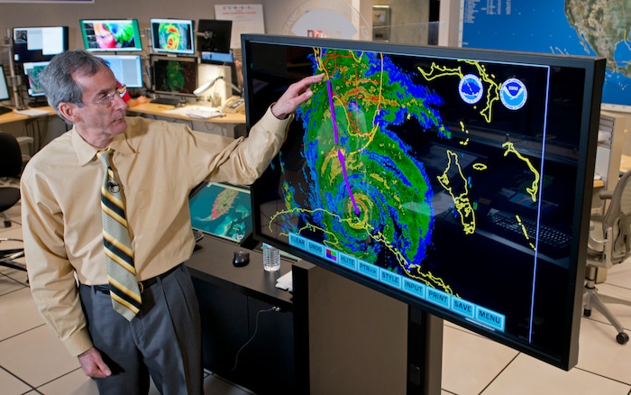 Ed Rappaport, the acting director of the National Hurricane Center, draws a line to illustrate the projected track of Hurricane Irma up Florida's west coast Saturday, Sept. 9, 2017 during a television interview. (AP Photo/Andy Newman)