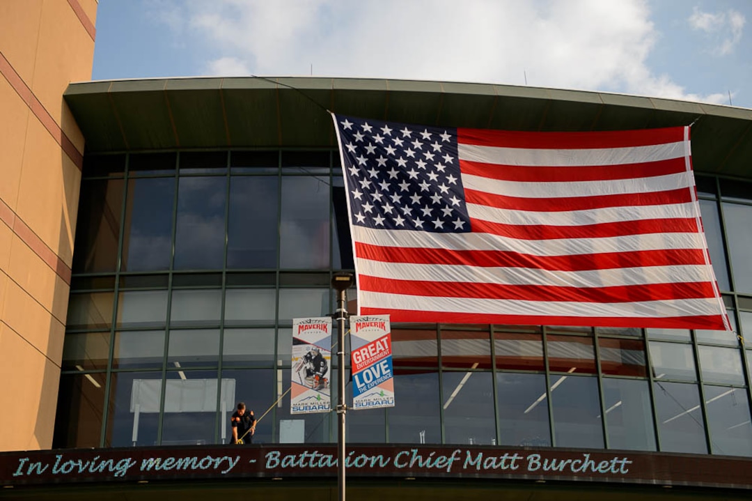 (Trent Nelson | The Salt Lake Tribune)  Firefighters secure a flag at the funeral services for Battalion Chief Matthew Burchett at the Maverik Center in West Valley City, Monday Aug. 20, 2018.
