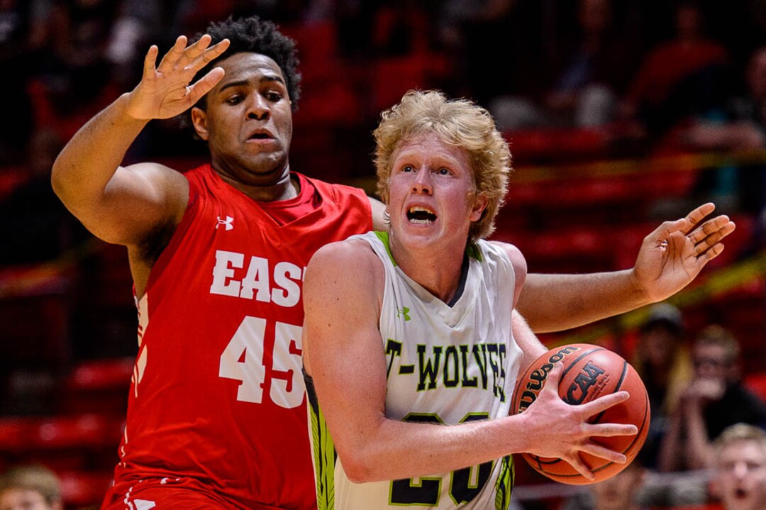 (Trent Nelson | The Salt Lake Tribune)  East vs. Timpanogos, 5A State high school basketball tournament at the Huntsman Center in Salt Lake City, Wednesday Feb. 28, 2018. Timpanogos's Logan Wilkey (20) defended by East's Mikey Frazier (45).