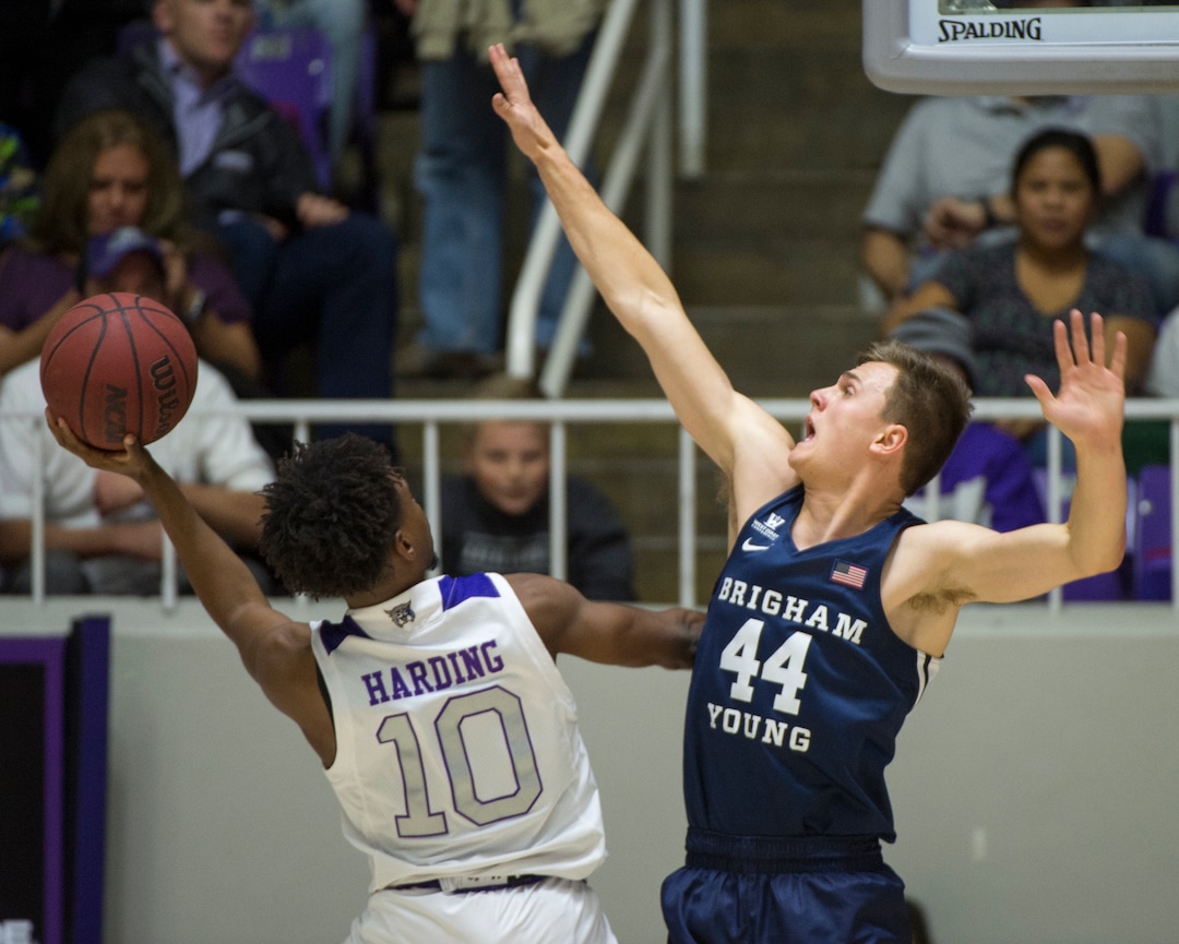 (Rick Egan  |  The Salt Lake Tribune)       Weber State guard Jerrick Harding (10) shoots over Brigham Young Cougars guard Connor Harding (44), in basketball action between Brigham Young Cougars and Weber State Wildcats, at the Dee Event Center in Ogden, Saturday, Dec. 1, 2018.