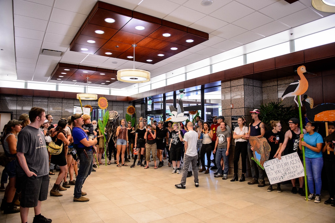 (Trent Nelson  |  The Salt Lake Tribune) Protesters occupy the lobby of the Chamber of Commerce Building in Salt Lake City on Tuesday, July 9, 2019. Dozens of people showed up to protest the proposed Inland Port and ended up clashing with police, resulting in temporary street closures and arrests.
