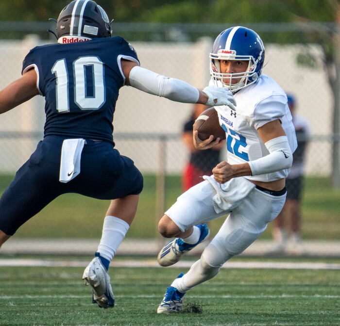 (Rick Egan | The Salt Lake Tribune) Dallen Martinez (12) runs for the Chargers as  Jackson Buehler defends for the Chargers, in defends for Bingham  prep football action between the Corner Canyon Chargers and the Bingham Miners, on Friday, Aug. 27, 2021.