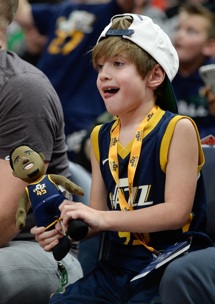 (Francisco Kjolseth  |  The Salt Lake Tribune)  Hudson Tyacke, 6, cheers on his team as he dances around with a stuffed Utah Jazz guard Donovan Mitchell (45) during the Jazz Pistons game at Vivint Smart Home Arena Monday, Jan. 14, 2019, in Salt Lake City.