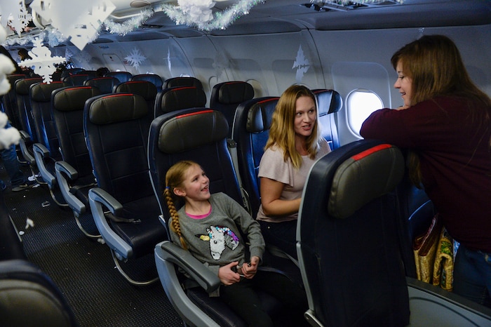 (Leah Hogsten | The Salt Lake Tribune) l-r Amalia Blanchard and her mother Becky Blanchard talk with Jessica Lindsey of Seattle as they await the Salt Lake City Gold Star families to board the flight. Ten Gold Star families from Salt Lake City were treated to a Winter Wonderland scene, including Whoville and the Grinch at their boarding gate at Salt Lake International Airport, Dec. 7, 2019 before their flight to Disney World aboard the Snowball Express. This month, the Gary Sinise Foundation's Snowball Express will fly more than 1,700 family members of fallen U.S. military heroes to Disney World for a holiday retreat.