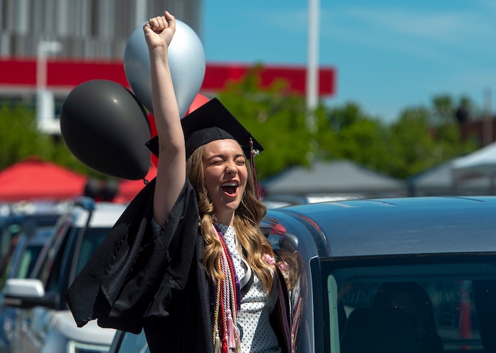 (Rick Egan  |  The Salt Lake Tribune)    Sara Holbrook celebrates her graduation as she rides in the parade of 2020 graduates  in a “drive through” graduation ceremony at Alta High, Thursday, May 28, 2020.