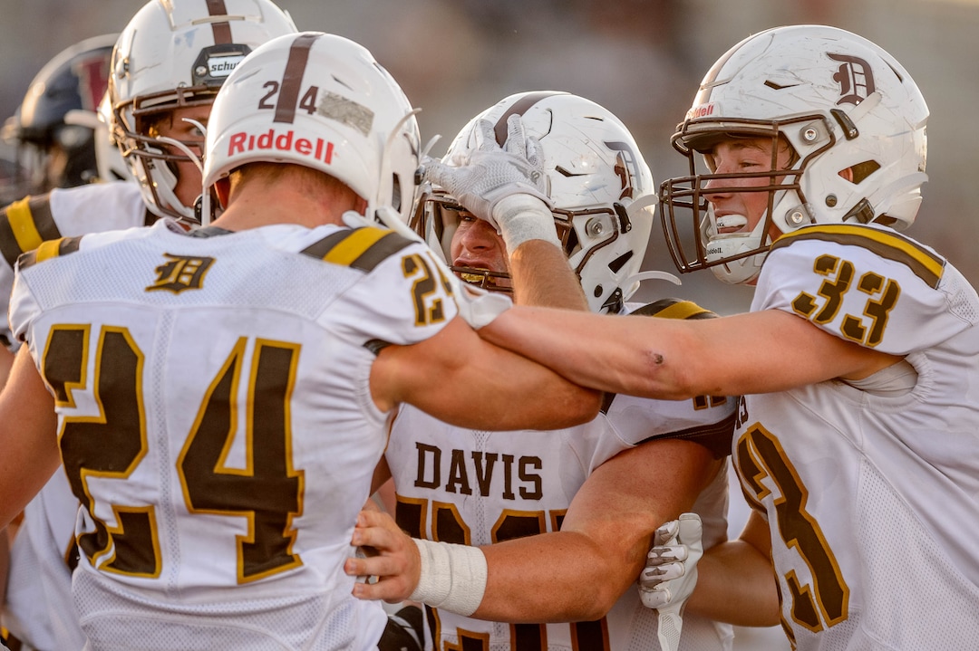 (Trent Nelson  |  The Salt Lake Tribune) Davis running back Spencer Ferguson (24) celebrates a touchdown with teammates as Herriman hosts Davis High School football, in Herriman on Thursday, Aug. 13, 2020.