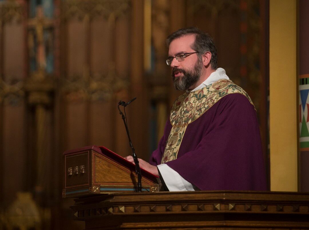 (Rick Egan  |  The Salt Lake Tribune)   The Reverend Christopher P. Gray, reads from the Gospel of Mathew, during the Ash Wednesday Mass, at the Cathedral of The Madeleine, Wednesday, Feb. 14, 2018.