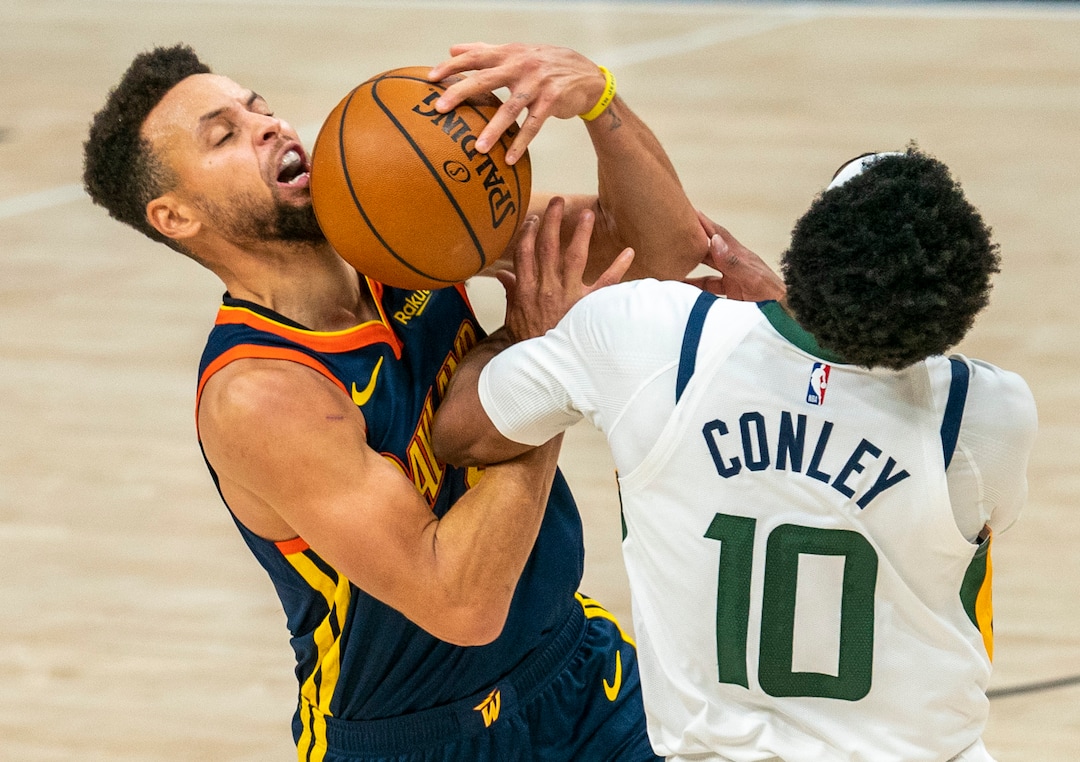 (Rick Egan | The Salt Lake Tribune) Golden State Warriors guard Stephen Curry (30) manages to score and draw a foul as he collides with Utah Jazz guard Mike Conley (10), in NBA action between the Utah Jazz and the Golden State Warriors at Vivint Arena, on  Saturday, Jan. 23, 2021.