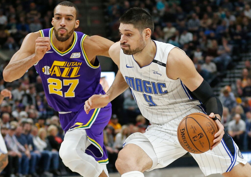 Orlando Magic center Nikola Vucevic (9) drives around Utah Jazz center Rudy Gobert (27) during the first half of an NBA basketball game Wednesday, Jan. 9, 2019, in Salt Lake City. (AP Photo/Rick Bowmer)