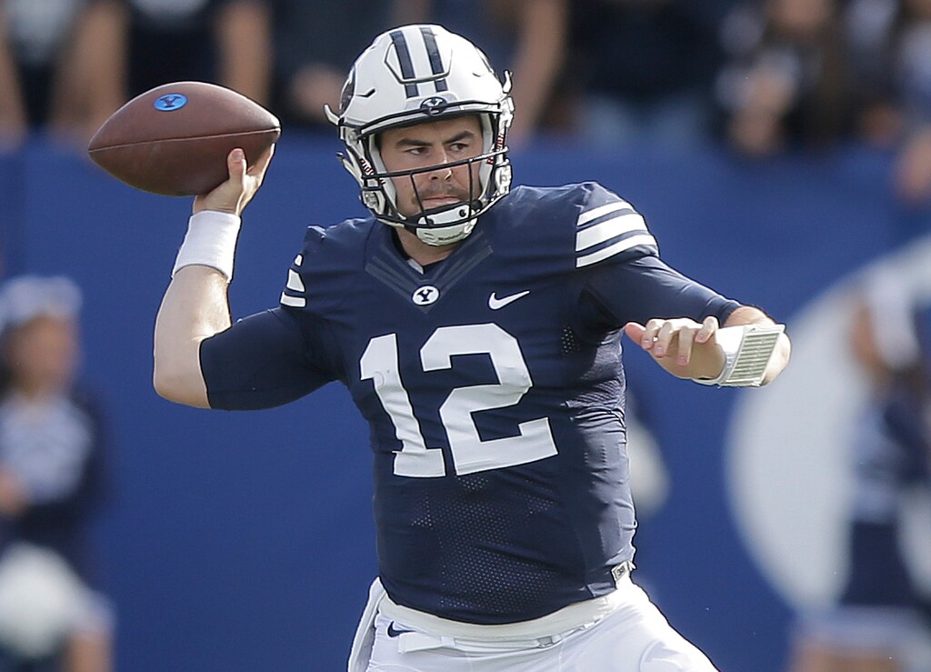 FILE - In this Nov. 12, 2016, file photo, BYU quarterback Tanner Mangum (12) passes in the first half during an NCAA college football game against Southern Utah, in Provo, Utah. BYU opens fall camp Thursday, July 27, 2017, with Tanner Mangum securely locked in as the starting quarterback. The strong-armed junior is finally the unquestioned leader after a phenomenal freshman year, but is also carrying a bigger weight on his shoulders besides an inexperienced offense after admitting this summer to dealing with depression and mental health issues. (AP Photo/Rick Bowmer, File)