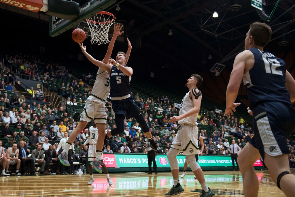 Utah State guard Sam Merrill (5) draws a foul from Colorado State forward Adam Thistlewood (31) during an NCAA college basketball game Tuesday, March 5, 2019, in Fort Collins, Colo (Timothy Hurst/The Coloradoan via AP)