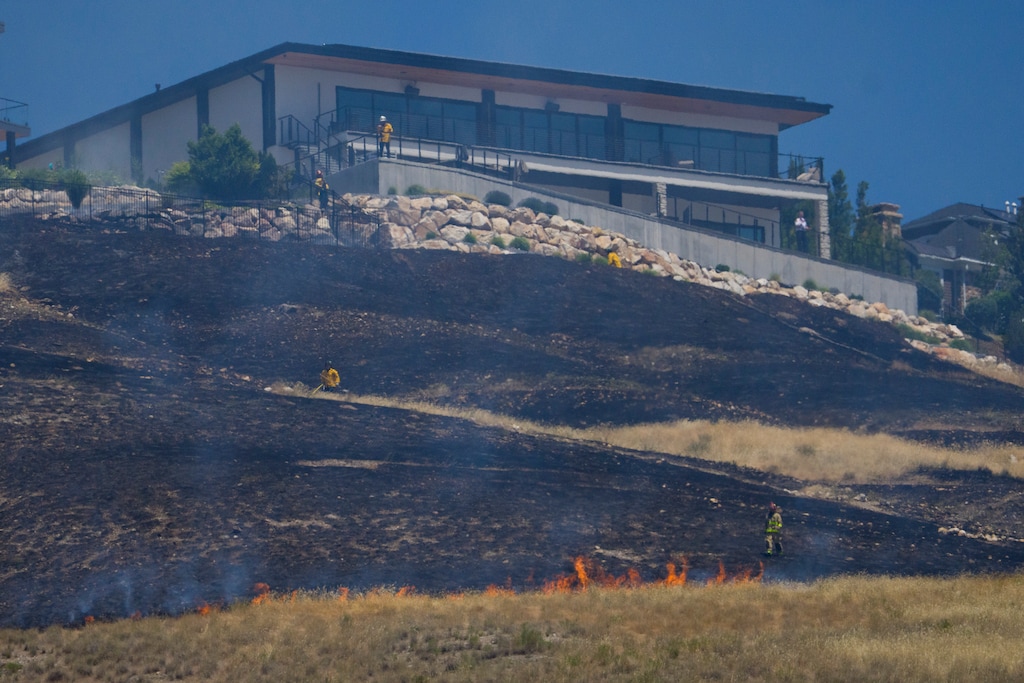 (Bethany Baker | The Salt Lake Tribune) Firefighters work to contain a brush fire near Ensign Peak in Salt Lake City on Wednesday, June 10, 2026.