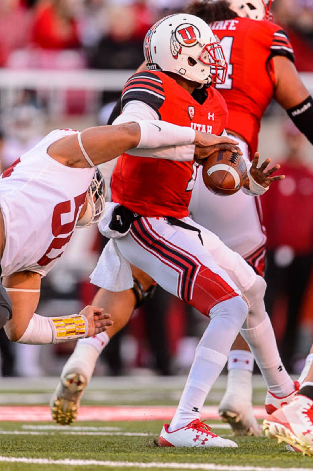 (Trent Nelson | The Salt Lake Tribune)  Washington State Cougars defensive lineman Hercules Mata'afa (50) strips the ball from Utah Utes quarterback Tyler Huntley (1) as the University of Utah hosts Washington State, NCAA football in Salt Lake City, Saturday November 11, 2017.
