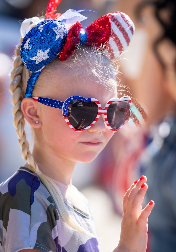 (Rick Egan | The Salt Lake Tribune) Lonnie Campbell, 6 waves as she watches the Cherry Days Fourth of July parade, in North Ogden, on Monday, July 4, 2022.