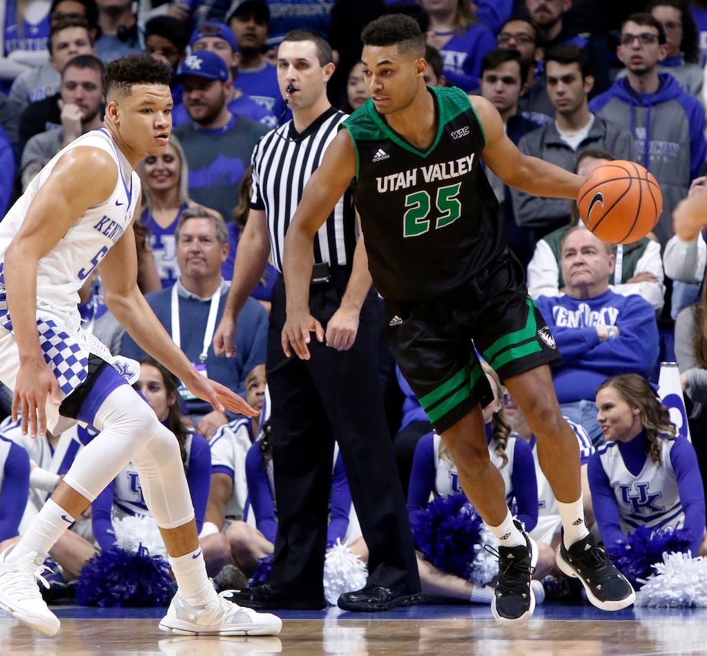 Utah Valley's Kenneth Ogbe (25) looks for an opening on Kentucky's Kevin Knox (5) during the first half of an NCAA college basketball game, Friday, Nov. 10, 2017, in Lexington, Ky. (AP Photo/James Crisp)
