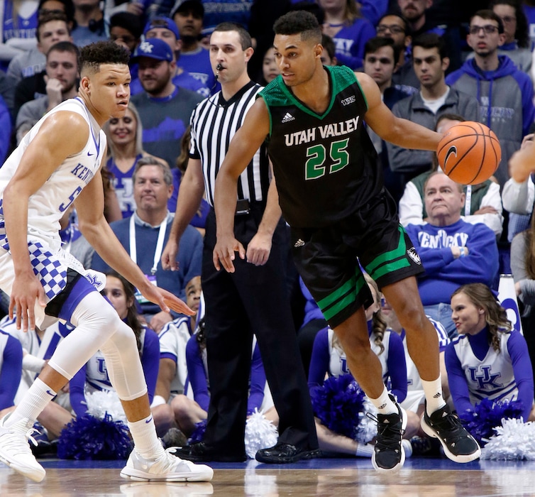 Utah Valley's Kenneth Ogbe (25) looks for an opening on Kentucky's Kevin Knox (5) during the first half of an NCAA college basketball game, Friday, Nov. 10, 2017, in Lexington, Ky. (AP Photo/James Crisp)