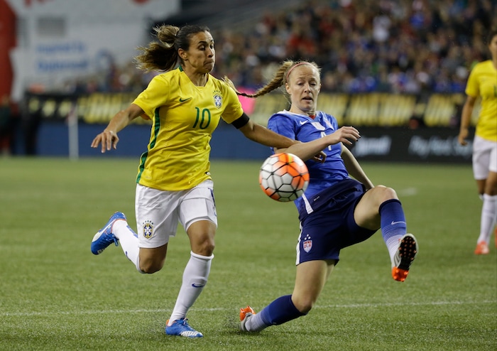 United States' Becky Sauerbrunn, right, vies for the ball with Brazil's Marta in a friendly soccer match Wednesday, Oct. 21, 2015, in Seattle. The match is part of a post-World Cup victory tour by the U.S. women's national team. (AP Photo/Elaine Thompson)