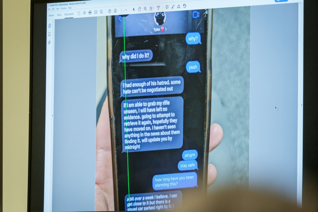 (Spenser Heaps | Pool) A photograph which prosecutors say shows a text message exchange between Tyler Robinson, who is accused in the fatal shooting of Charlie Kirk, and Robinson’s roommate and romantic partner Lance Twiggs, is shown during a preliminary hearing at the Fourth District Courthouse in Provo, Thursday, July 9, 2026.