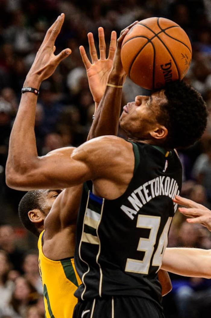 (Trent Nelson | The Salt Lake Tribune)  Milwaukee Bucks forward Giannis Antetokounmpo (34) and Utah Jazz guard Alec Burks (10) fumble for a rebound, as the Utah Jazz host the Milwaukee Bucks, NBA basketball in Salt Lake City Saturday November 25, 2017.