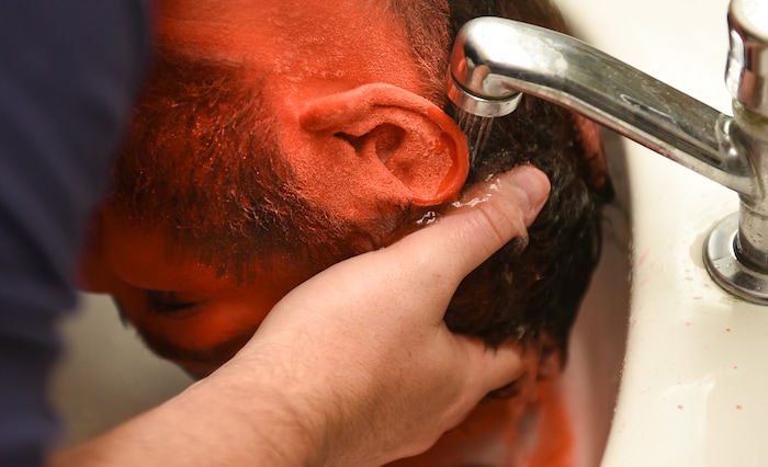 (Francisco Kjolseth | The Salt Lake Tribune) BYU and Utah fan alike Brad Klekas of South Jordan cleans up after a photo shoot in the Tribune studio for a story on fans who cheer both teams.