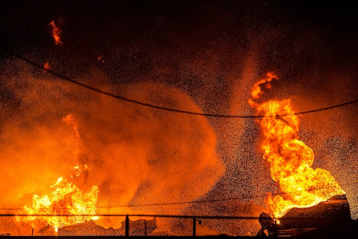 (Chris Detrick  |  The Salt Lake Tribune)  Firefighters attempt to put out a burning semitrailer that was hauling thousands of gallons of fuel on Interstate-15 in Midvale Thursday, January 18, 2018.   Lt. Todd Royce of the Utah Highway Patrol said the truck was southbound on the interstate at 7500 South at 7:20 p.m. when a tire caught fire, sending flames toward the tanks.