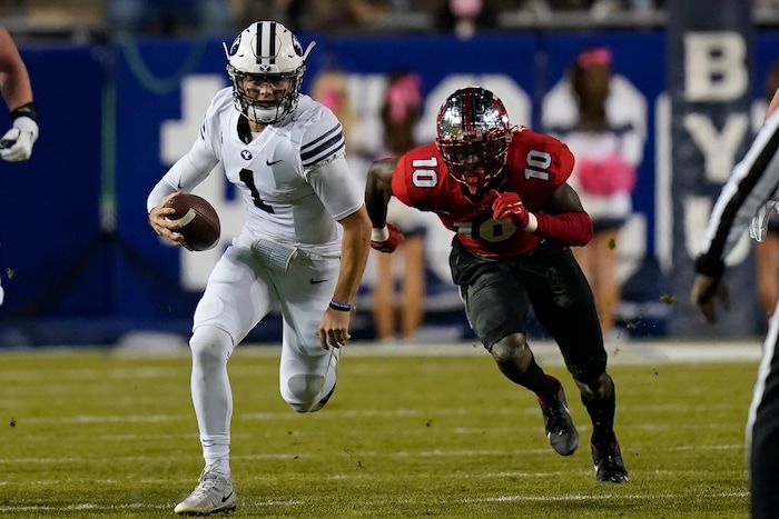 BYU quarterback Zach Wilson (1) out runs Western Kentucky defensive end DeAngelo Malone (10) during the first half of an NCAA college football game Saturday, Oct. 31, 2020, in Provo, Utah. (AP Photo/Rick Bowmer, Pool)