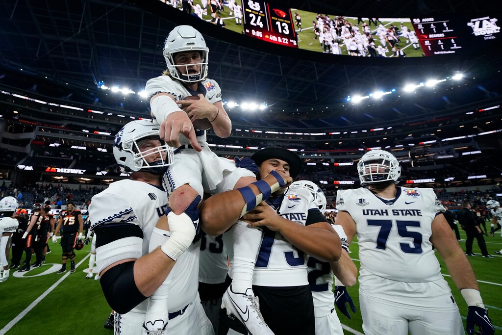 (Ashley Landis | AP) Utah State quarterback Cooper Legas (5) is hoisted on the shoulders of his teammates after they won the LA Bowl 24-13 over Oregon State in Inglewood, Calif., Saturday.