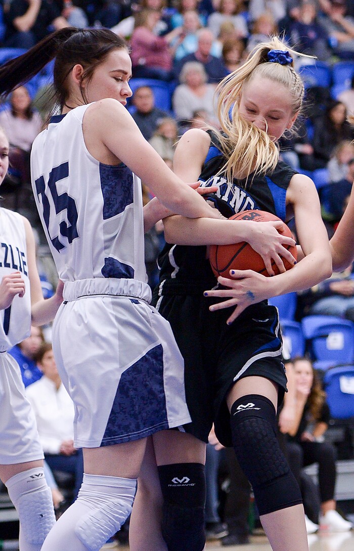 (Leah Hogsten  |  The Salt Lake Tribune)  Pleasant Grove's Sydney Valgardson tangles with Copper Hills' Kaci Bobo under the net.  Copper Hills High School girls' basketball team defeated Pleasant Grove High School 66-25 during their Class 6A girls' basketball playoff opener at Salt Lake Community College Tuesday, Feb. 20, 2018. 