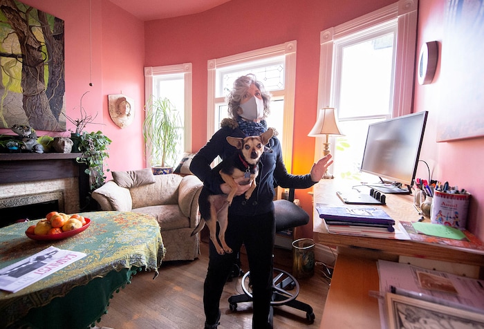 (Francisco Kjolseth  |  The Salt Lake Tribune) Greta deJong, longtime publisher of Catalyst magazine, a Salt Lake City-based magazine for wellness and other New Age topics, talks about the magazine’s HQ, a large pink house, called “Big Pink,” that is also her home on the top floor, as she holds her dog Malia. The magazine is ending its print run after nearly 40 years — shifting to online publication.