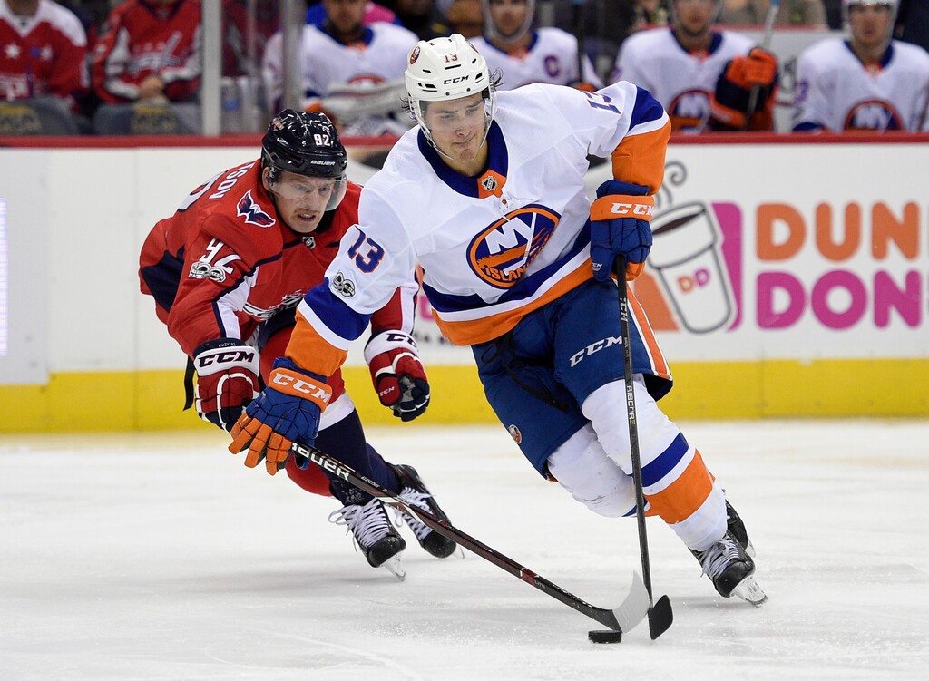 New York Islanders center Mathew Barzal (13) skates with the puck against Washington Capitals center Evgeny Kuznetsov (92), of Russia, during the second period of an NHL hockey game, Thursday, Nov. 2, 2017, in Washington. (AP Photo/Nick Wass)