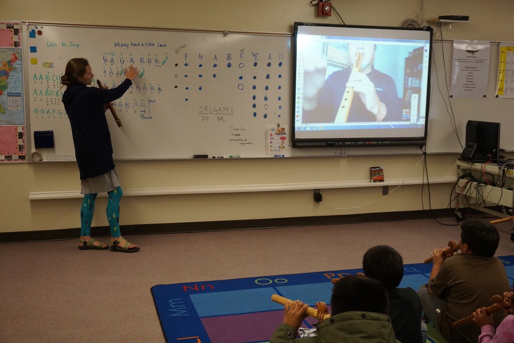 (Zak Podmore | Tribune file photo) Third grade teacher Sarah Burak and musician Vince Redhouse co-teach a Native flute lesson at the Bluff Elementary School in October 2019.