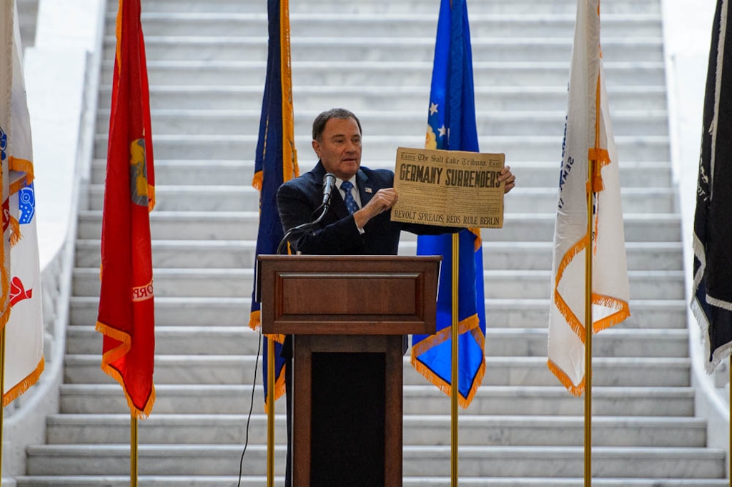 (Trent Nelson | The Salt Lake Tribune) Governor Gary Herbert holds a copy of The Salt Lake Tribune with a headline indicating Germany's surrender. Commemoration of WW1 Armistice 100th Anniversary, in Salt Lake City on Thursday Nov. 8, 2018.