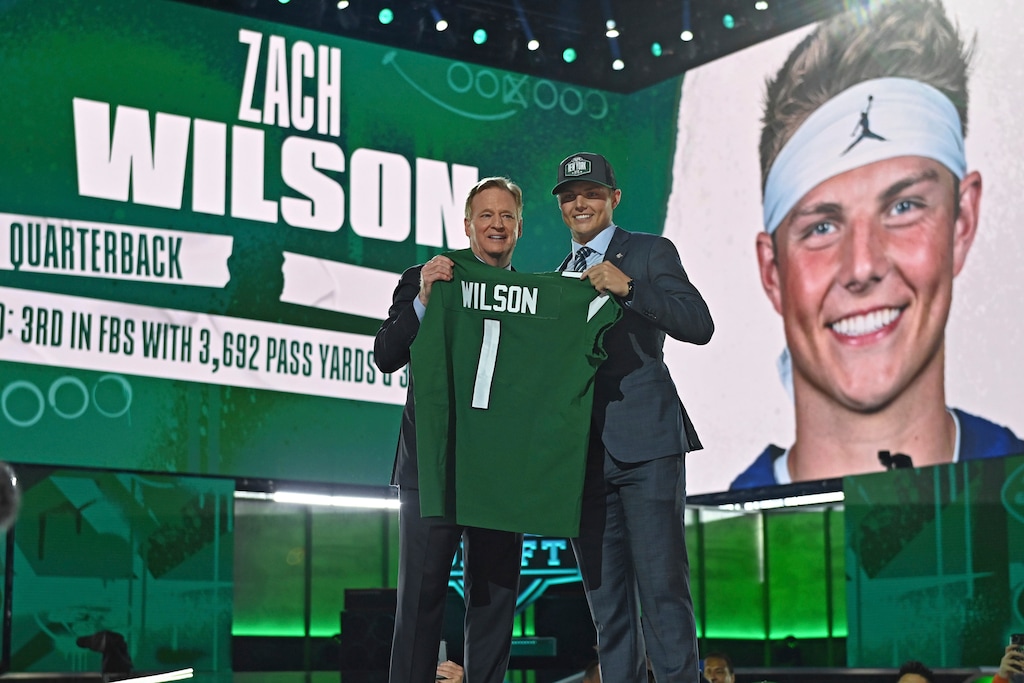 (David Dermer | AP) BYU quarterback Zach Wilson, right, holds a team jersey with NFL Commissioner Roger Goodell after the New York Jets selected Wilson with the second pick in the first round of the NFL football draft Thursday, April 29, 2021, in Cleveland.