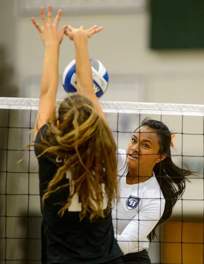 (Steve Griffin | The Salt Lake Tribune) Asiah Sopoaga of Copper Hills hits a shot through the Herriman defense during volleyball match at Copper Hills High School in West Jordan Tuesday September 26, 2017.