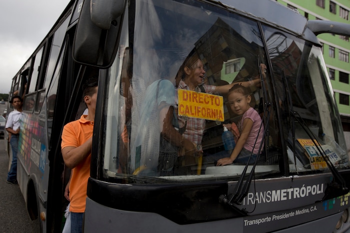 Voters ride a bus arranged by the opposition that transports voters to new polling stations during regional elections in Caracas, Venezuela, Sunday, Oct. 15, 2017. Elections could tilt a majority of the states' 23 governorships back into opposition control for the first time in nearly two decades of socialist party rule, though the government says the newly elected governors will be subordinate to a pro-government assembly. (AP Photo/Fernando Llano)