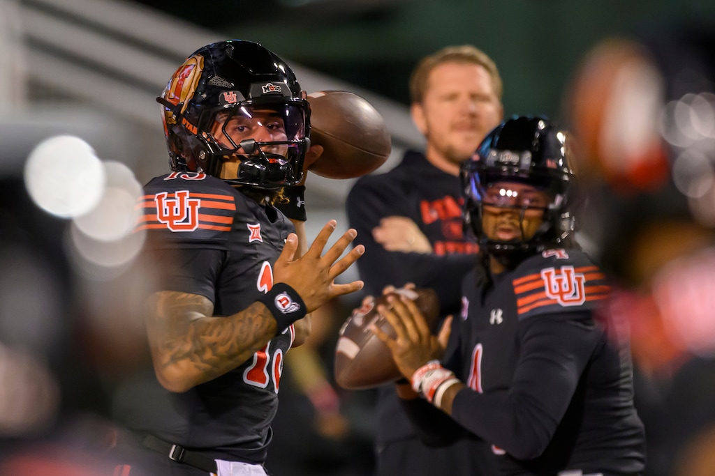 (Tyler Tate | AP) Utah quarterback Byrd Ficklin, left, and quarterback Devon Dampier, right, warm up before an NCAA college football game against Cincinnati, Saturday, Nov. 1, 2025, in Salt Lake City, Utah.