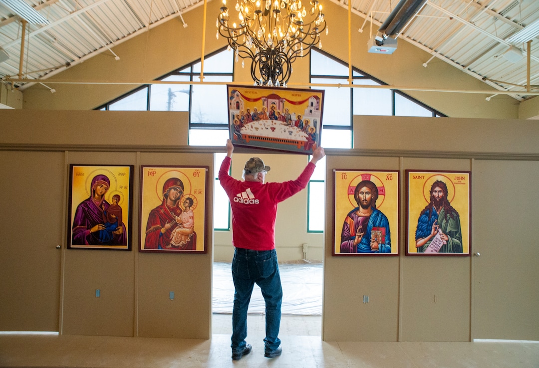 (Rick Egan  |  The Salt Lake Tribune)    Chuck Karpakis hangs one of the icons, in the new St. Anna Orthodox Church in Sandy, Friday, Jan. 24, 2020.