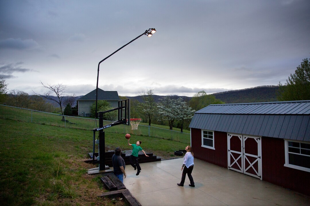 Robby Wilson, 10, plays basketball with his grandparents Cathy, right and Eddy Sweat, who have custody of him in Jacksboro, Tenn., Monday, April 23, 2018. Their daughter, Robby's mother, Krystle Sweat, sits in jail a mile away. The Sweats have raised Krystle's son since he was about 3. Over the years, they've paid her rent, bought her cars, and invited her and her boyfriend to share their home. She wound up stealing tools, a computer and camera _ anything she could pawn. (AP Photo/David Goldman)