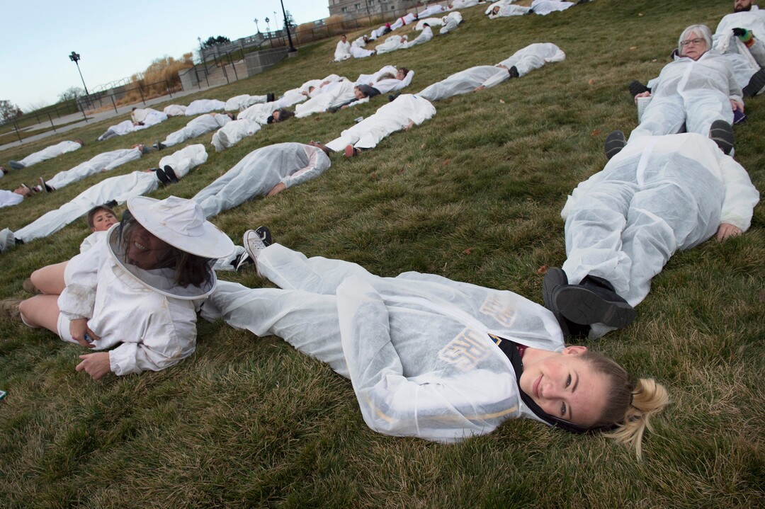 (Scott Sommerdorf   |  The Salt Lake Tribune)   Protesters dressed in white jumpsuits spelled out "GO HOME TRUMP" on the south lawn of the Utah State Capitol, Sunday, December 3, 2017, during a protest organized by artist Cat Palmer ahead of Trump's visit Monday. 