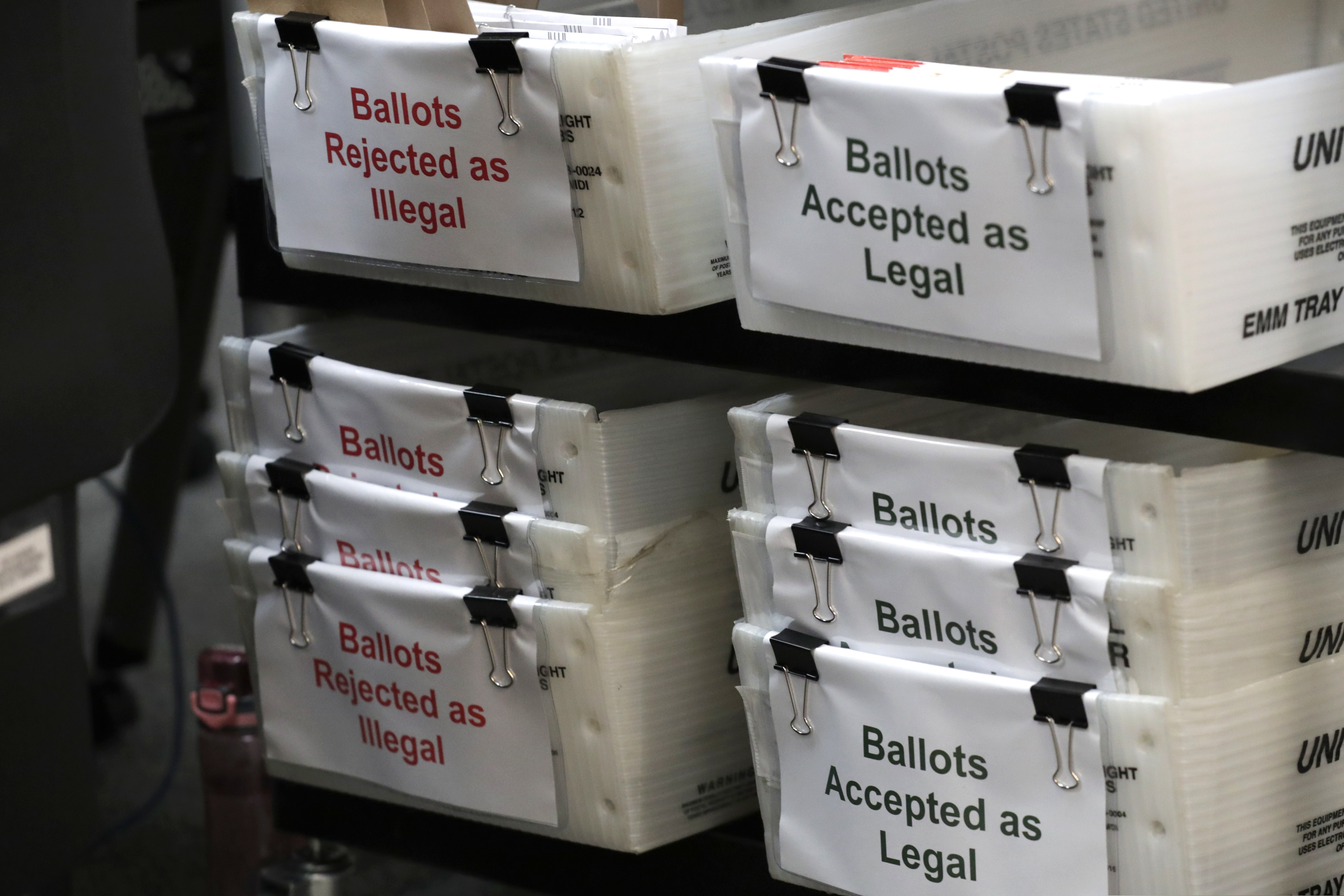 (Lynne Sladky | AP file photo)
In this July 30, 2020, file photo, boxes for illegal and legal vote-by-mail ballots are shown as the the Miami-Dade County canvassing board meets to verify signatures on vote-by-mail ballots for the Aug. 18 primary election at the Miami-Dade County Elections Department in Doral, Fla. Never in U.S. history will so many people exercise the right on which their democracy hinges by marking a ballot at home.