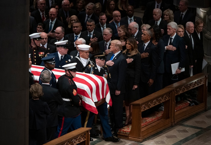 The flag-draped casket of former President George H.W. Bush is carried by a military honor guard past former President George W. Bush and wife Laura Bush, President Donald Trump, first lady Melania Trump, former President Barack Obama, Michelle Obama, former President Bill Clinton, former Secretary of State Hillary Clinton, former President Jimmy Carter, and Rosalynn Carter during a State Funeral at the National Cathedral, Wednesday, Dec. 5, 2018, in Washington. (AP Photo/Carolyn Kaster)
