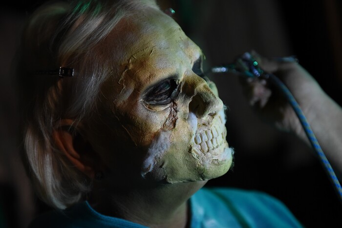(Francisco Kjolseth  |  The Salt Lake Tribune)  State Senator Karen Mayne undergoes a drastic transformation with the help of makeup artist Jez Roberts as local politicians fall prey to the zombie apocalypse at the Fear Factory on Thursday, Oct. 12, 2017, for a special event to raise awareness of the Utah Food Bank and kick start donations. 