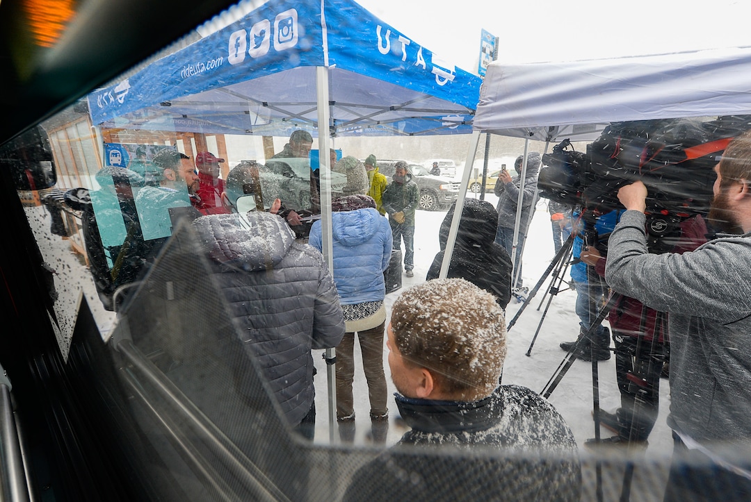 (Francisco Kjolseth  |  The Salt Lake Tribune)  UTA and Central Wasatch Commission members gather at the Big Cottonwood Canyon park and ride lot on Monday, Nov. 25, 2019, as the snow flies to remind residents about improvements to ski buses that will begin service on Nov. 29.