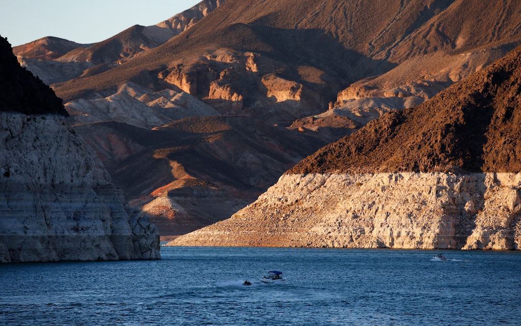FILE - In this July 20, 2014 file photo, a bathtub ring of light minerals shows the high water line near Hoover Dam on Lake Mead at the Lake Mead National Recreation Area in Nevada. Six states in the U.S. West that rely on the Colorado River to sustain cities and farms rebuked a plan to build an underground pipeline that would transport billions of gallons of water through the desert to southwest Utah. In a joint letter Tuesday, Sept. 8, 2020, water officials from Arizona, California, Colorado, Nevada, New Mexico and Wyoming urged the U.S. government to halt the approval process for the project, which would bring water 140 miles (225 km) from Lake Powell in northern Arizona to the growing area surrounding St. George, Utah. (AP Photo/John Locher,File)