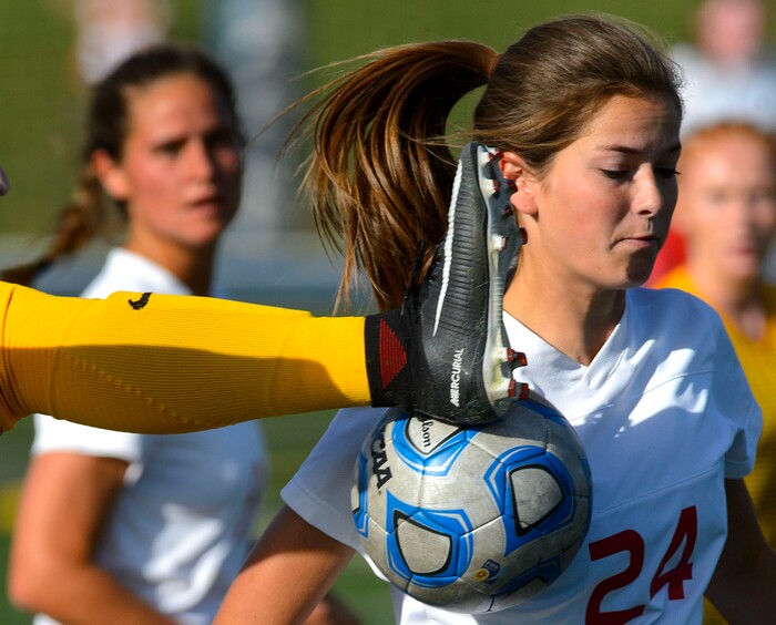 (Steve Griffin | The Salt Lake Tribune) East's Scarlett Williams avoids a high kick during East's 5A semifinal girl's soccer match against Maple Mountain at Juan Diego High School in Draper Tuesday October 17, 2017.