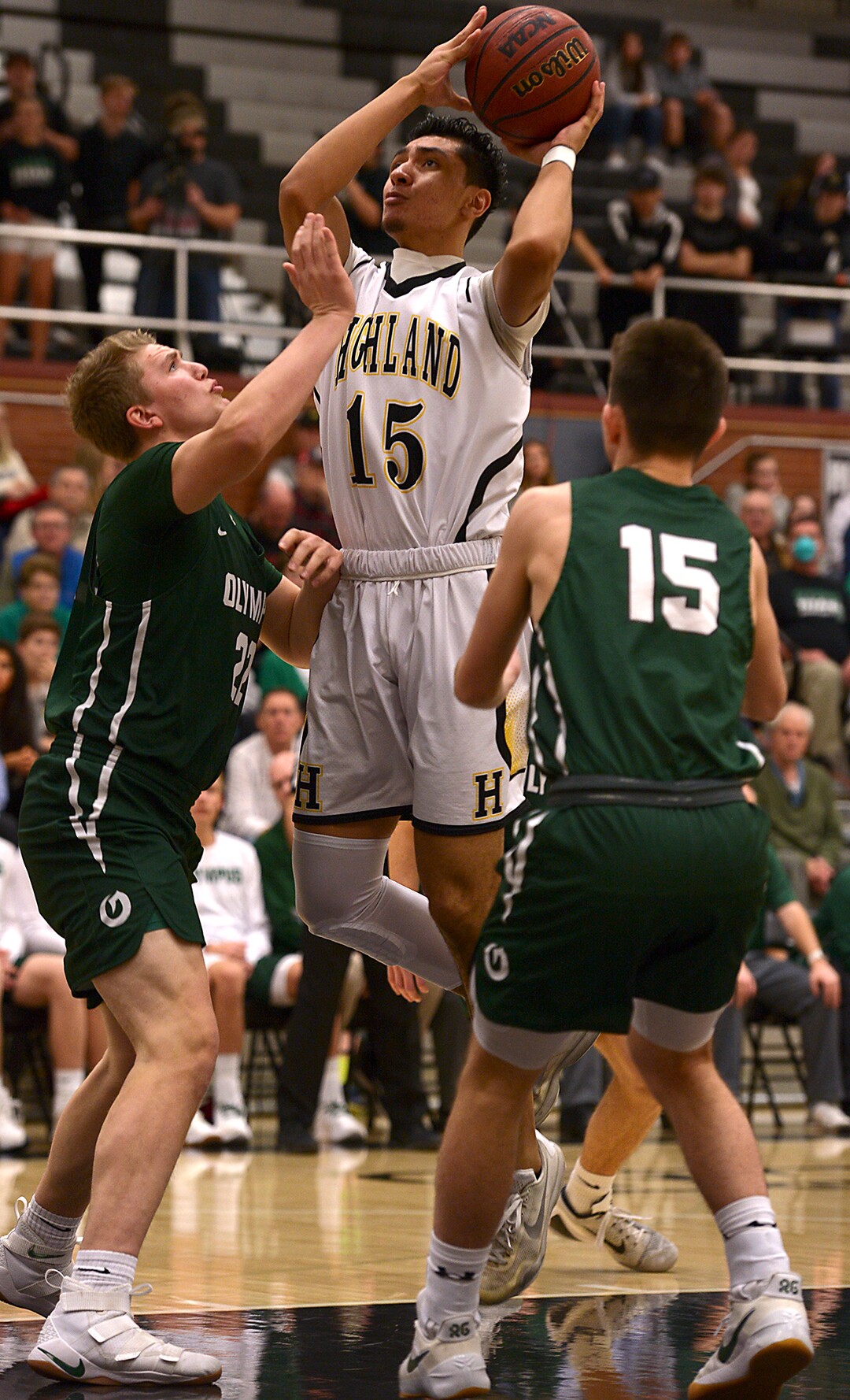 (Leah Hogsten  |  The Salt Lake Tribune) Highland's Richard Tialavea shoots around Olympus' Spencer Jones. Olympus High School defeated Highland High School 86-54 during their basketball game, Tuesday, February 6, 2018.